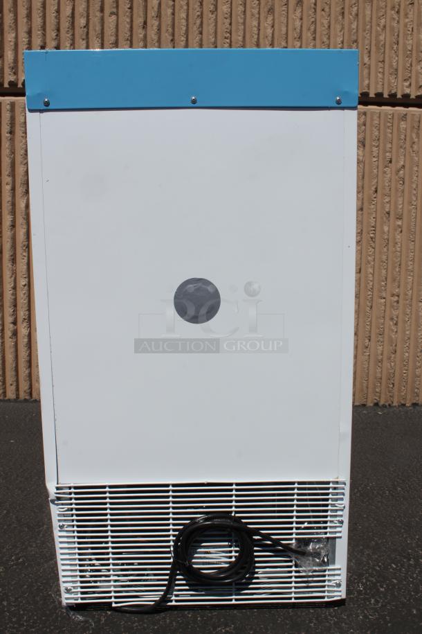 White outdoor refrigeration unit with a blue top, vented bottom, and coiled cord. Visible scuff marks, in used condition.