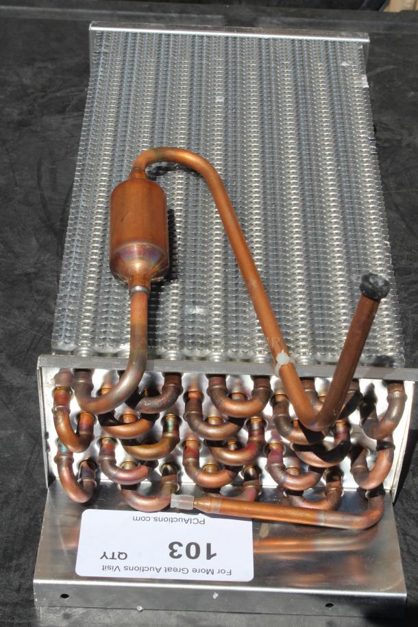Copper coil heat exchanger with aluminum fins, featuring intricate copper tubing. Visible tag reads "Lot 103."