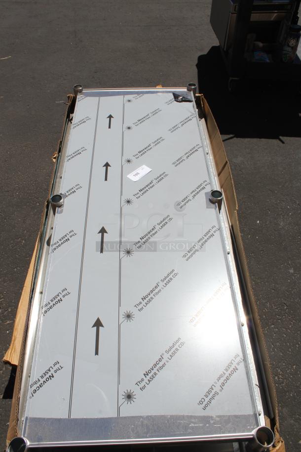 Rectangular metal panel with protective film, featuring "Novacel Solution for LASER Fiber" markings, in original packaging.