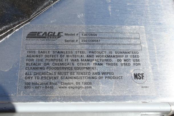 Eagle Group stainless steel product label, Model T3072SGS, Serial 2501230587, NSF certified, warranty details shown.