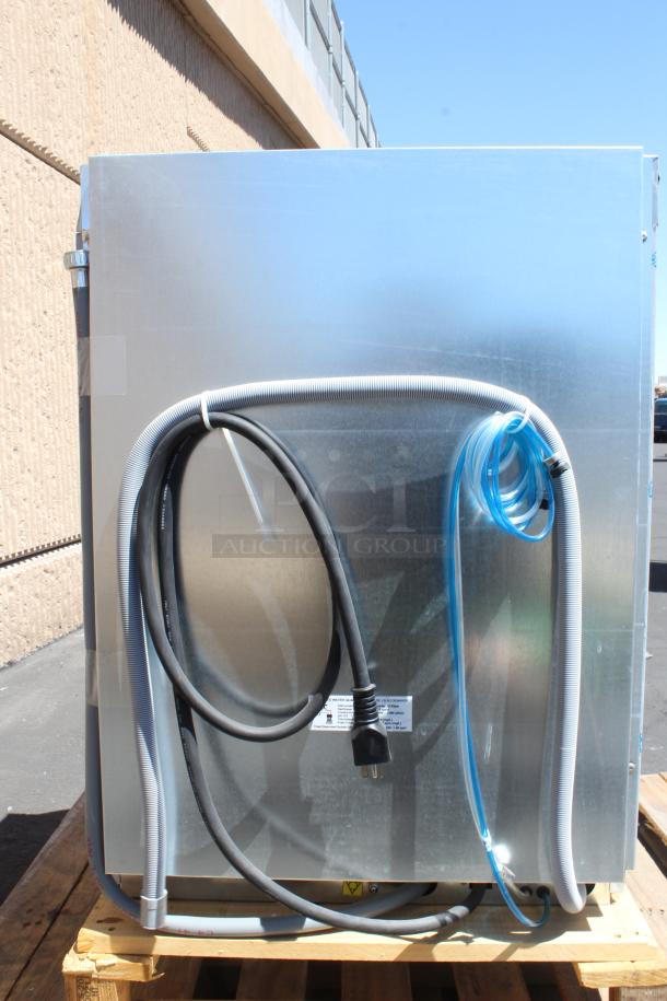Commercial dishwasher on a pallet, back view showing wiring and hoses, stainless steel finish, appears new.