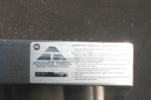 Advance Tabco stainless steel label with NSF logo. Includes cleaning instructions for maintaining sink bowl condition.