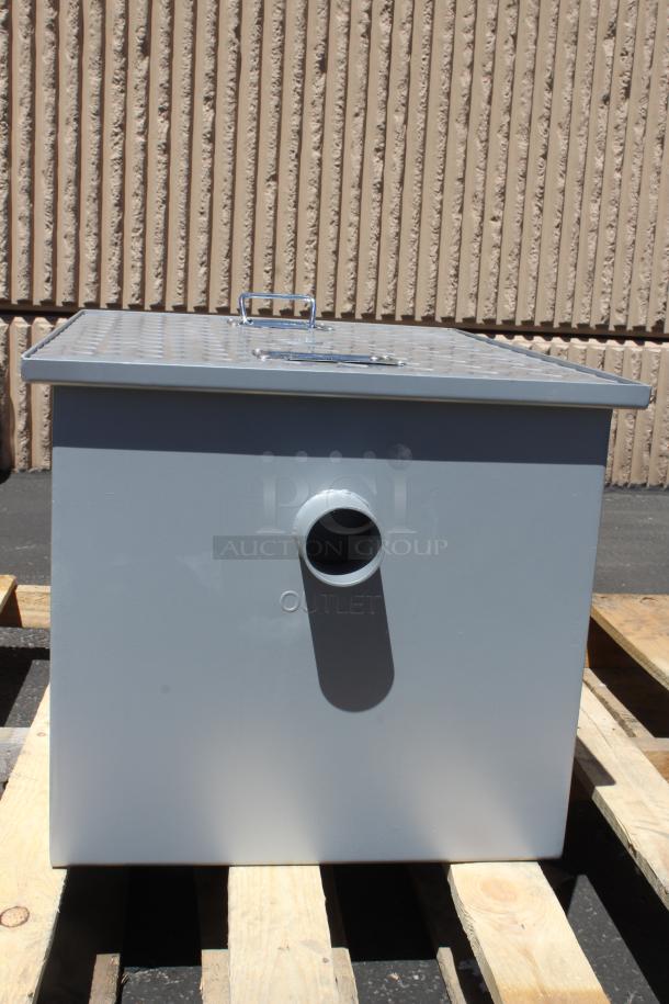 Gray metal box with outlet pipe, sturdy lid with handle, and "OUTLET" marking, in excellent condition on wooden pallet.