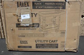 Box for Lavex utility cart, featuring a black premium handle and 8" soft rubber casters. 550 lb capacity. Box appears worn.