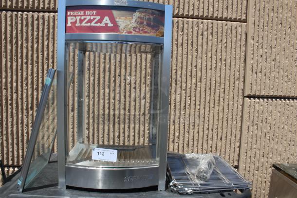 Commercial pizza warmer with stainless steel frame and glass sides, featuring "Fresh Hot Pizza" sign. Includes racks and accessories. Condition: used.