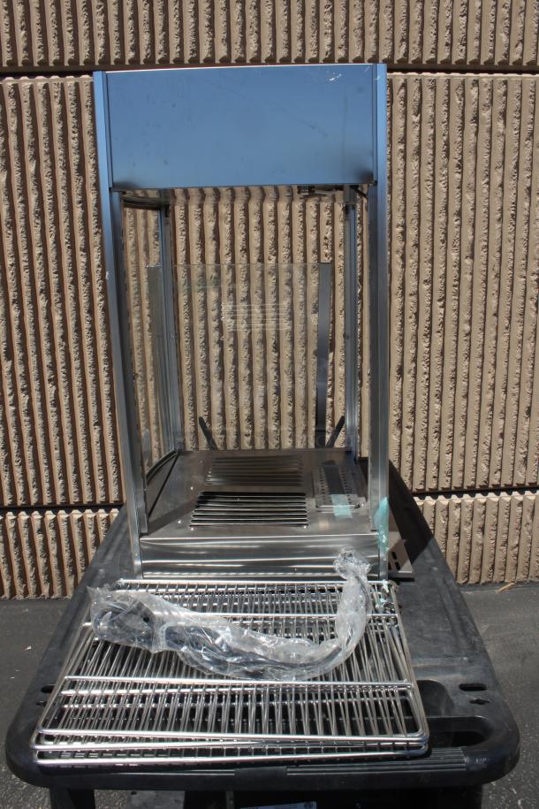 Stainless steel display case with glass sides, includes removable racks. Good condition, some minor surface scratches.