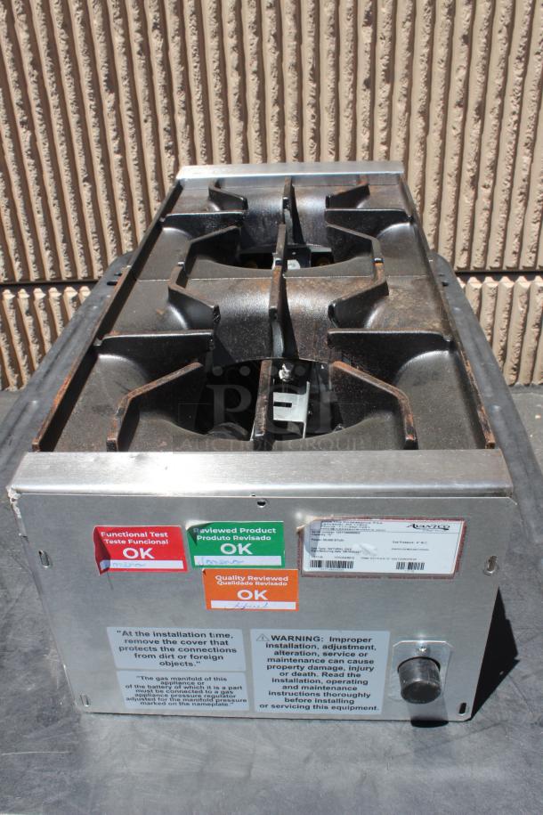 Commercial stovetop with four burners, stainless steel finish, tags indicate functional tests and quality reviews as "OK."