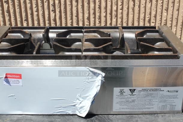 Stainless steel commercial gas stovetop by Avantco, featuring six burners. Protective plastic partially removed. UL listed label visible.