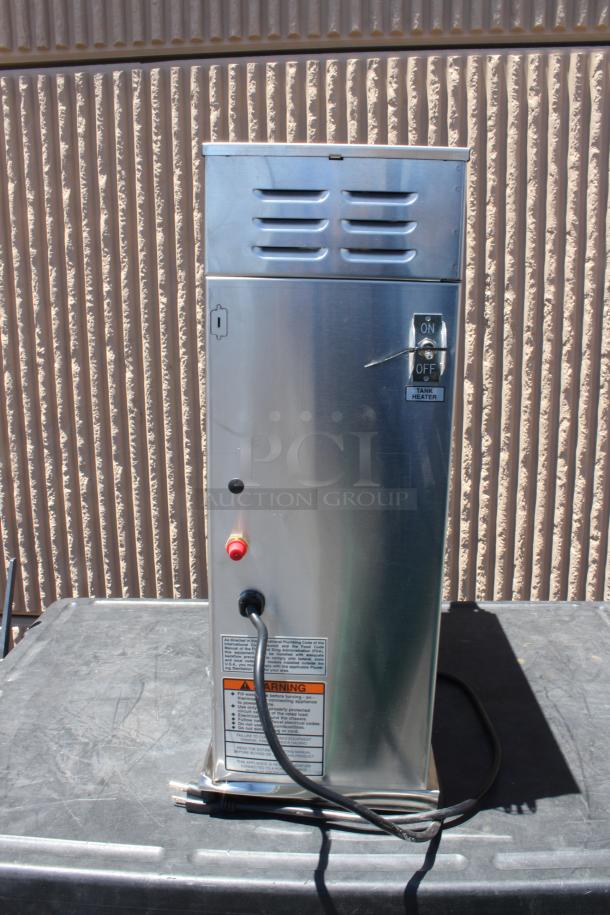 Stainless steel commercial tank heater with on/off switch, warning labels, and power cord; in good condition.