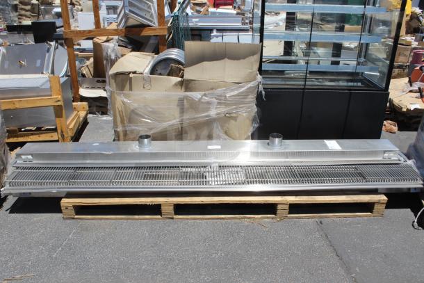 Commercial stainless steel air curtain, industrial design, good condition, on pallet, with mounting fixtures, visible duct ports.