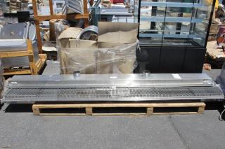 Commercial stainless steel air curtain, industrial design, good condition, on pallet, with mounting fixtures, visible duct ports.