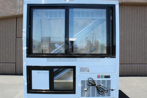 Large, blue vending machine with dual glass display windows, metal interior, and control panel with switches. Power cable attached.