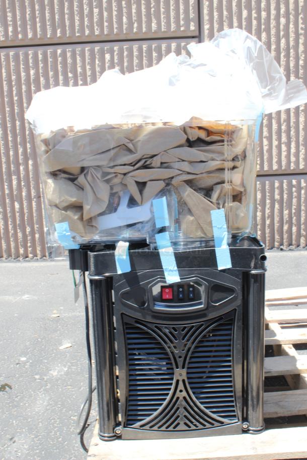 Large black commercial appliance with control switches, wrapped in plastic and paper, showing signs of outdoor storage.