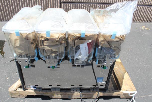 Four-compartment commercial beverage dispenser, new condition, clear plastic containers with lids, mounted on a pallet.