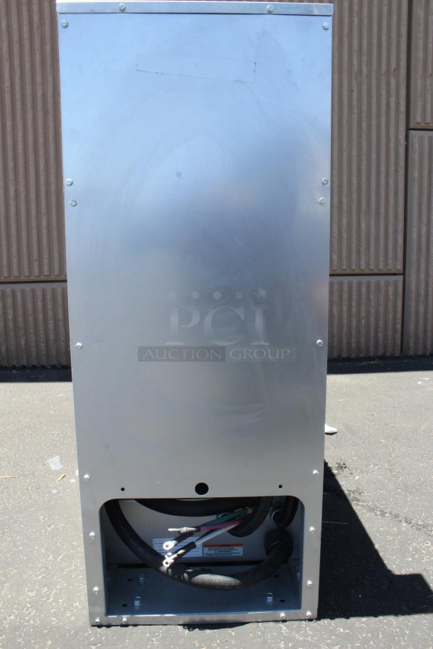 Metal industrial unit, likely an HVAC component, in used condition. Exposed wiring and labels suggest electrical connections.