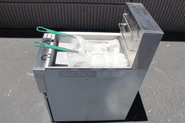 Commercial deep fryer with stainless steel body, green-handled baskets, good condition, no visible branding.