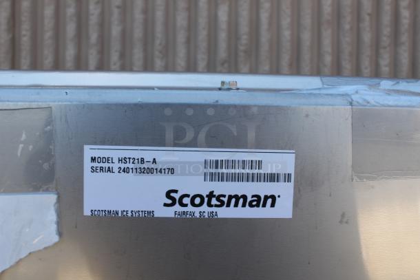 Scotsman ice machine, model HST21B-A, serial 24011320014170, Fairfax, SC USA. Metal exterior with minor wear.