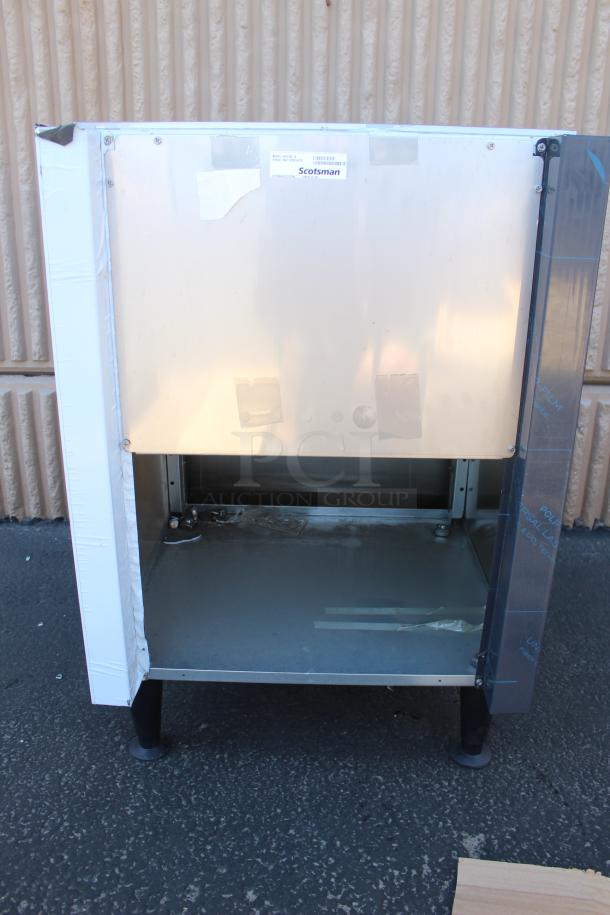 Scotsman commercial ice machine cabinet, stainless steel, pre-owned, some wear, model label visible.
