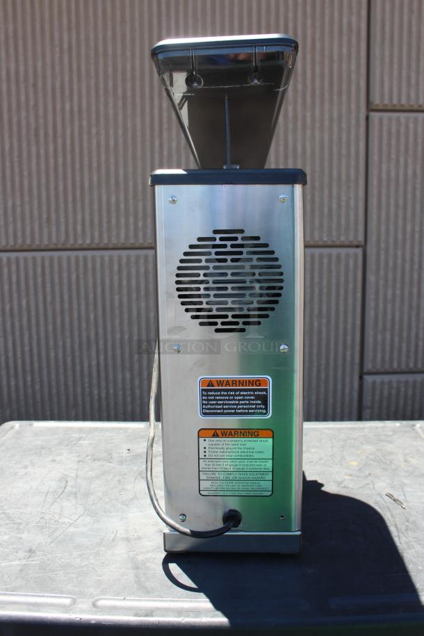 Commercial coffee grinder with stainless steel body and black plastic hopper. Features visible warning labels indicating electrical safety precautions. Good condition.
