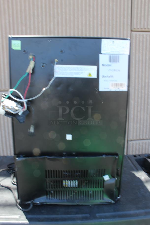 Black appliance rear view showing wiring, labels, and serial numbers. Marks of use visible. Model: WY004438.