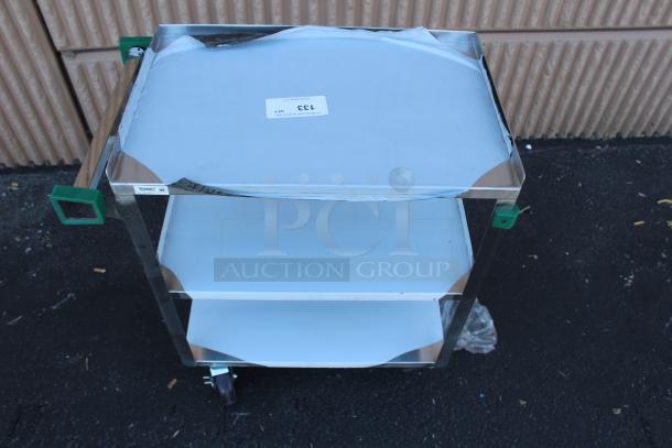 Stainless steel rolling utility cart with three shelves, protective film partially covering surfaces, and a sticker labeled "133".