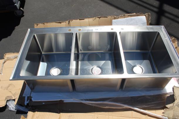 Triple basin stainless steel sink in excellent condition, with pre-drilled faucet holes and visible label marked "134".