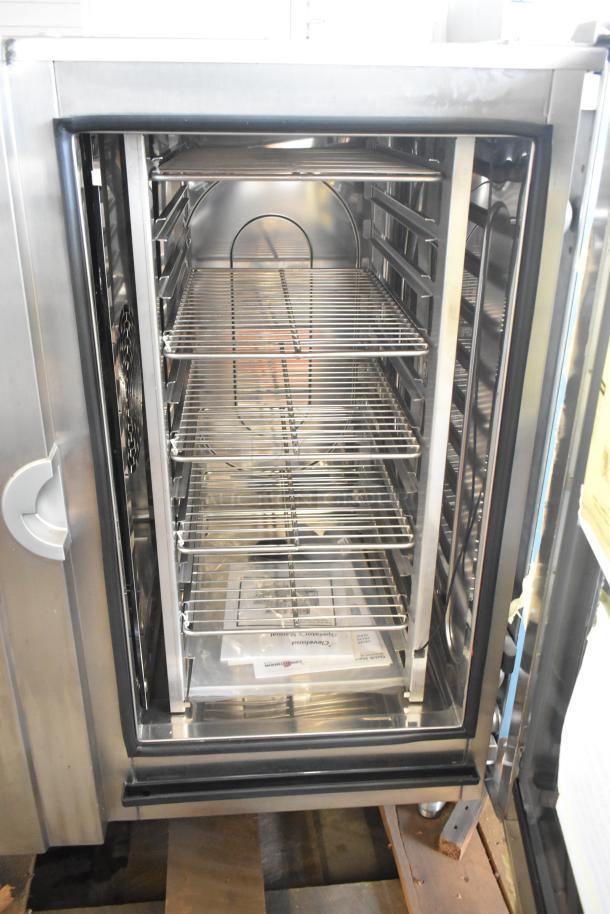 Brand new 2023 Cleveland OEB-10.10 combi convection oven, stainless steel, electric, 440/480V, 3-phase, interior racks visible.
