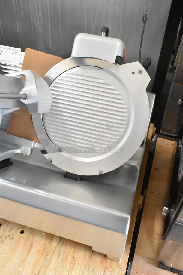 Brand new Globe SG13A-07 stainless steel meat slicer with blade sharpener, 220V, 1 phase, slight scratch and dent.