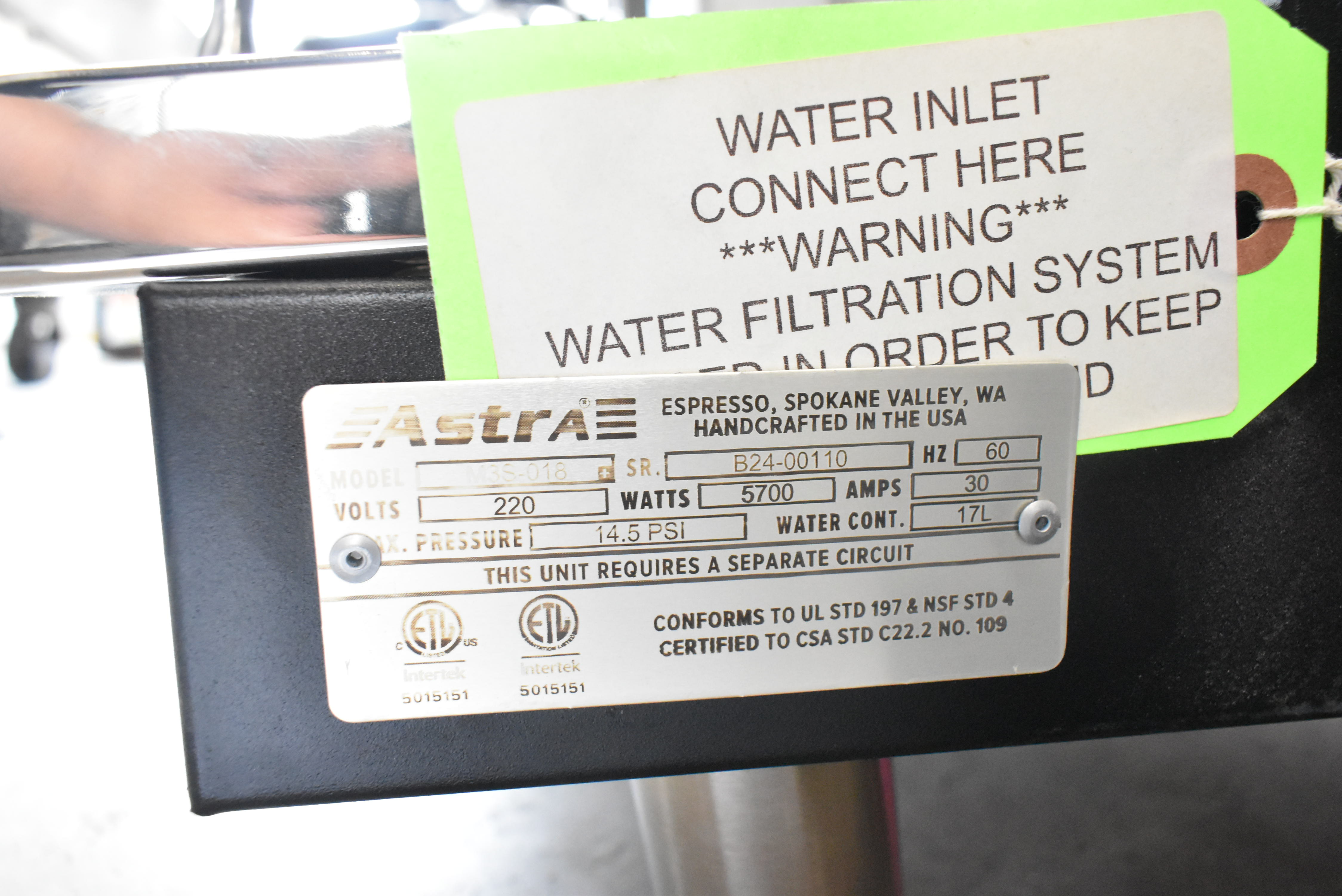 Espresso machine specification plate showing voltage requirements