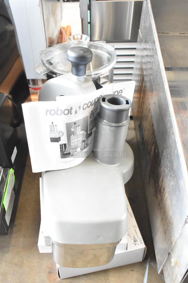 Brand new Robot Coupe R402 commercial food processor with bowl, continuous feed head, grating, slicing, dicing kits. 120V.