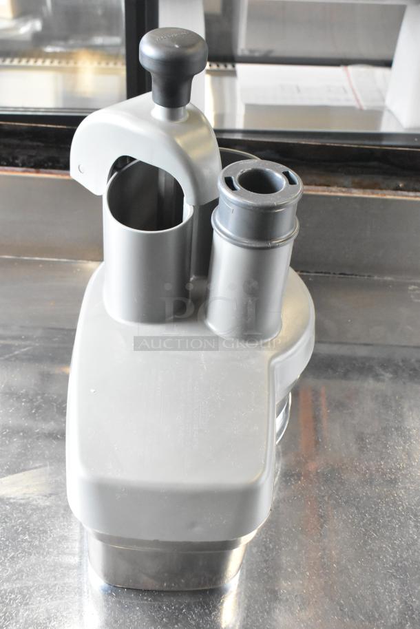 Brand new Robot Coupe R402 food processor with metal body, bowl, continuous feed head, grating, slicing discs, and dicing kit.