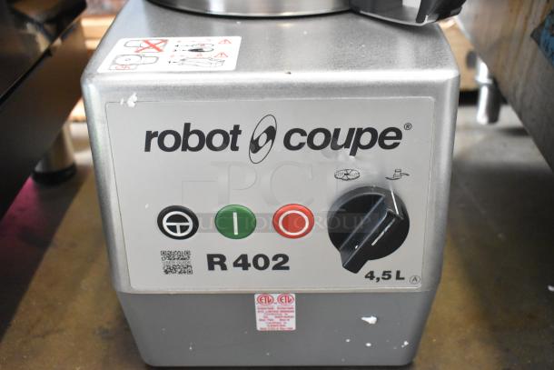 Brand new Robot Coupe R402 food processor, metal design, countertop model. Includes grating, slicing, and dicing kits. 120V.
