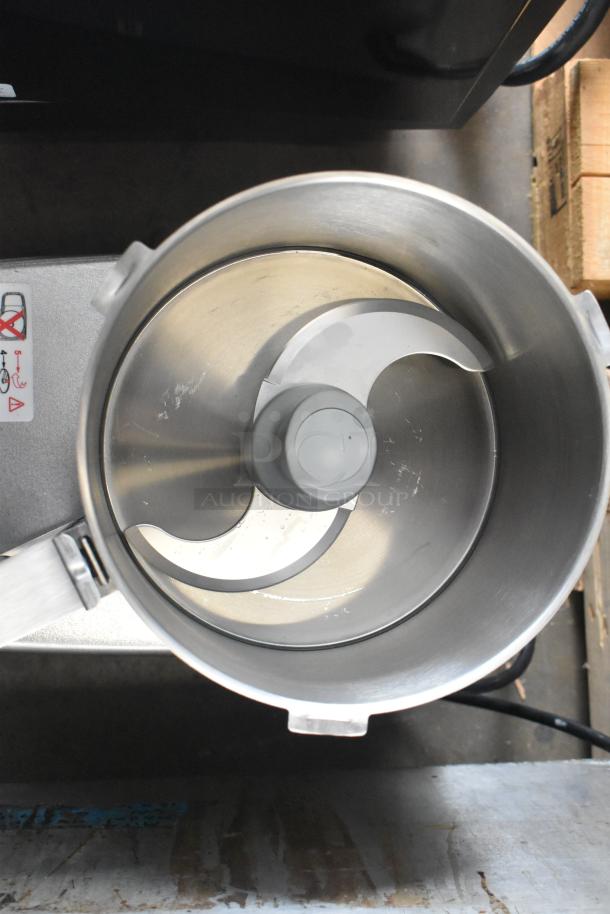 Brand new Robot Coupe R402 commercial food processor, metal, includes bowl and continuous feed head, shown top view.