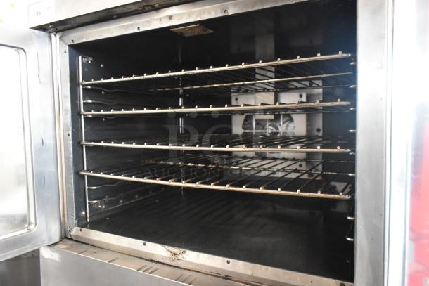 Vulcan VC4CD stainless steel convection oven with view-through doors, metal racks, and thermostatic controls on casters.