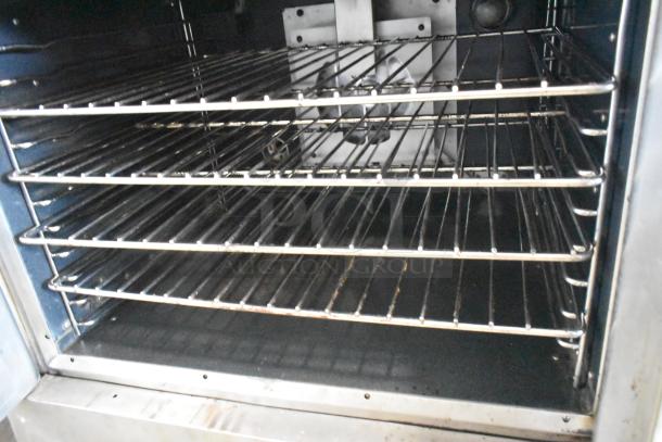 Vulcan VC4CD stainless steel convection oven, interior view showing metal racks. Features include view-through doors and thermostatic controls.