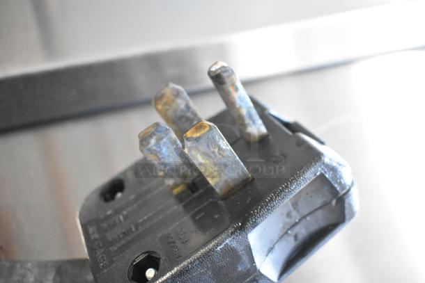 Close-up of a three-prong industrial power plug, part of a 2019 Pitco Frialator SE14 commercial fryer system.