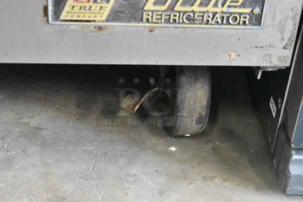 True TSSU-48-12 commercial prep table caster, visible branding, worn condition, 115V, 1 phase.