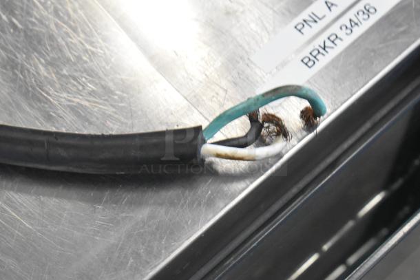 Frayed wires on Cadco Unox XAF195 convection oven with visible label reading "PNL A BRKR 34/36," indicating power specifications.