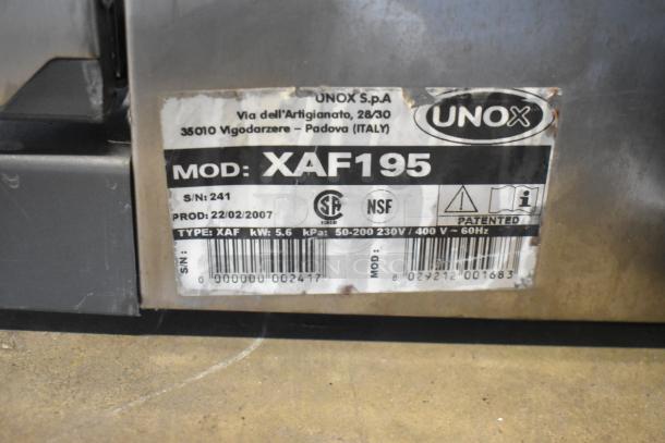 Cadco Unox XAF195 convection oven label showing model, serial number, production date, and voltage specifications.