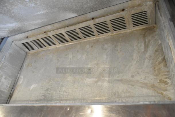 Leader ESSM48 stainless steel prep table interior, showing wear and surface scratches. Used condition, commercial grade.
