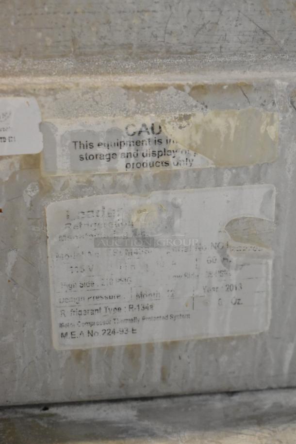 Leader ESSM48 stainless steel prep table label showing model and voltage specifications, set on commercial casters.