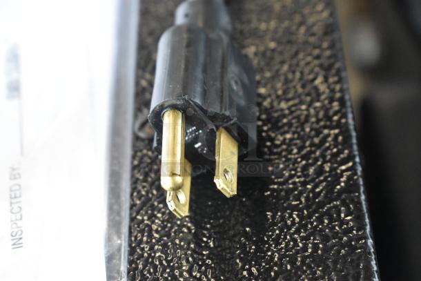 A close-up of a power plug for the Grindmaster Grind N Brew commercial coffee maker.