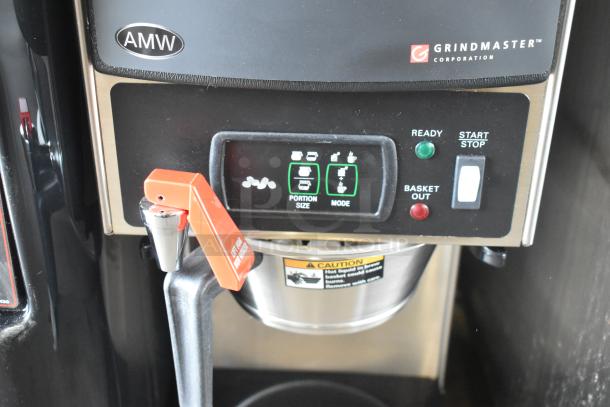 Grindmaster Grind N Brew stainless steel countertop coffee maker with hot water dispenser, metal brew basket, control panel.