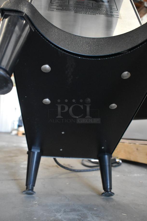 Grindmaster Grind N Brew stainless steel commercial coffee maker base with black legs and visible fixings.