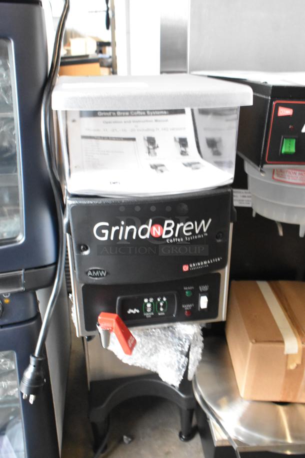 Grindmaster Grind N Brew stainless steel coffee grinder and maker with hot water dispenser and metal brew basket, on countertop.