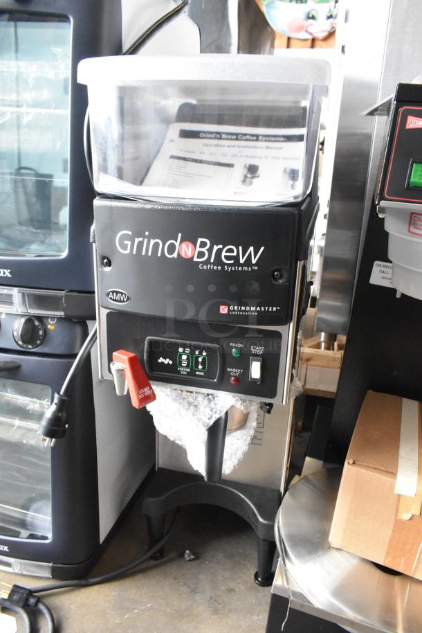 Grindmaster Grind N Brew commercial coffee bean grinder and maker, stainless steel, with hot water dispenser and metal brew basket.