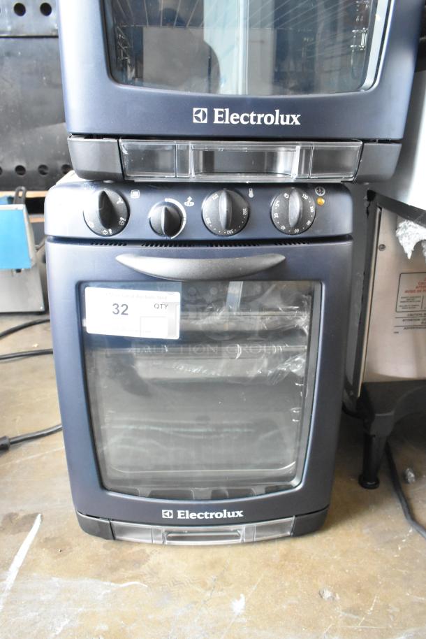 BRAND NEW Electrolux OTS100 Metal Countertop Mini Combi Steamer, 110V, 1 Phase. Slight scratches. Auction tag visible.