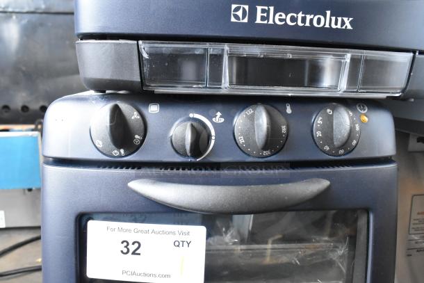 Brand new Electrolux OTS100 metal countertop mini combi steamer, 110V, 1 phase. Visible scratch and dent on surface.