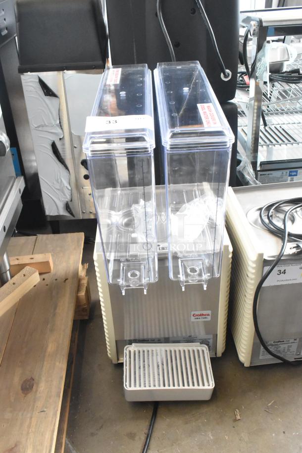 Brand new Crathco E27/E29-4 commercial beverage machine with 2 hoppers, metal body, 115 volts, minor scratches and dents.