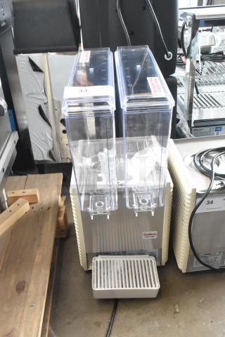 Brand new Crathco E27/E29-4 commercial beverage machine with 2 hoppers, metal body, 115 volts, minor scratches and dents.